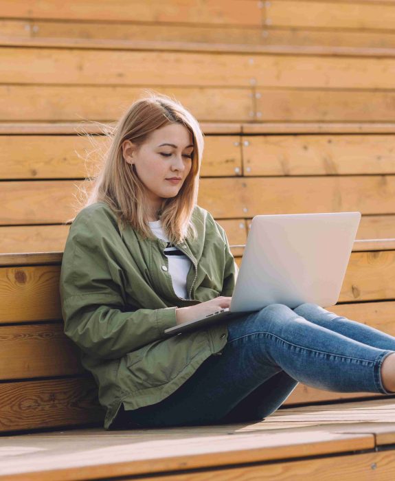 girl-with-a-silver-laptop-on-her-knees-resting-on-EELY35H-scaled.jpg girl-with-a-silver-laptop-on-her-knees-resting-on-EELY35H-scaled.jpg